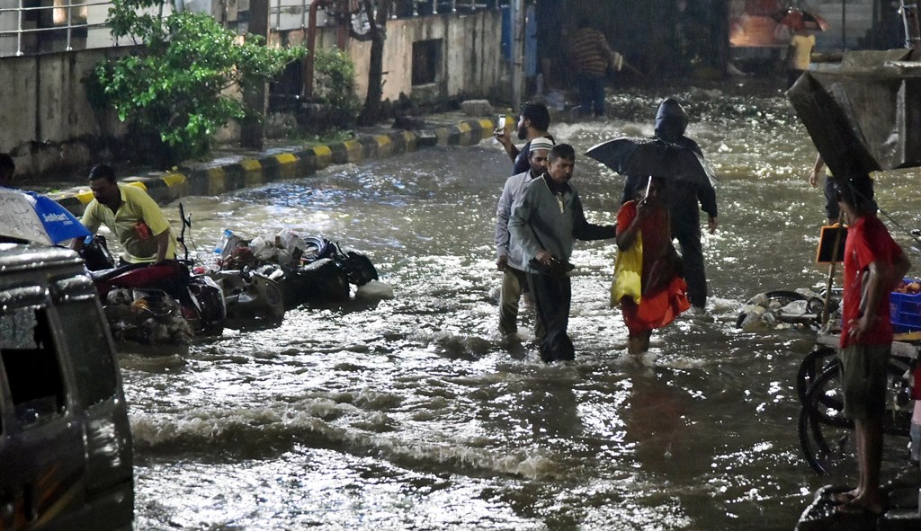 heavy rain in city, vehicles washed away, water entered shops and houses